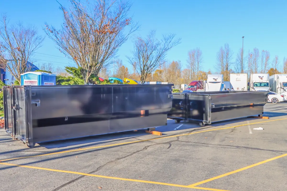 Professional dumpster rental service with roll-off container on residential driveway in Eagle